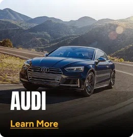 Audi driving on a mountainside road. Click to learn more.