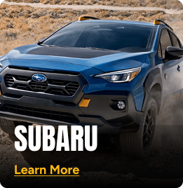 Blue Subaru driving on a dirt road. Click to learn more.
